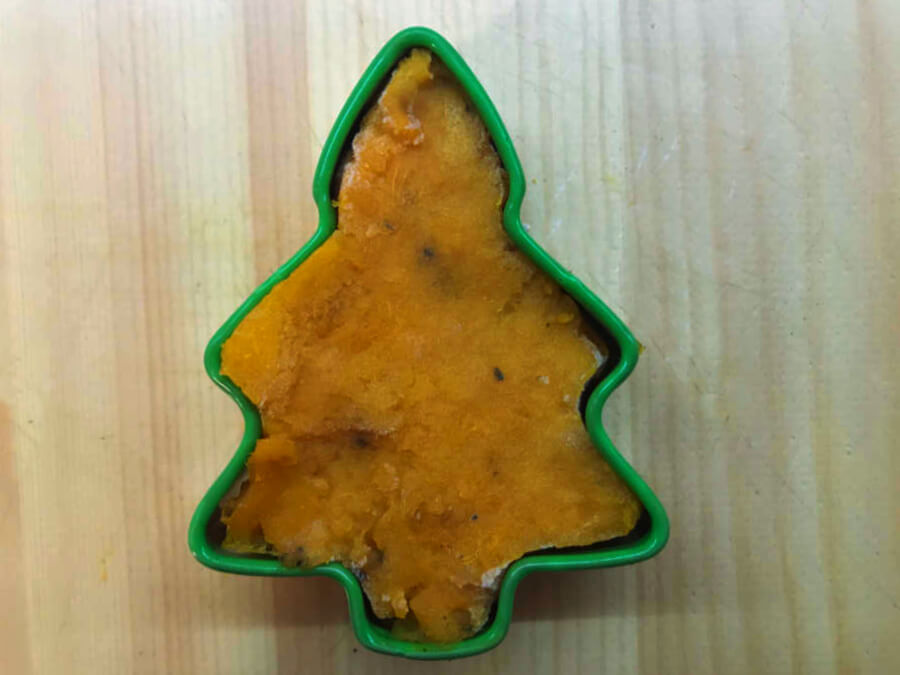 Sweet potato flesh pushed into a cookie cutter tree mould.