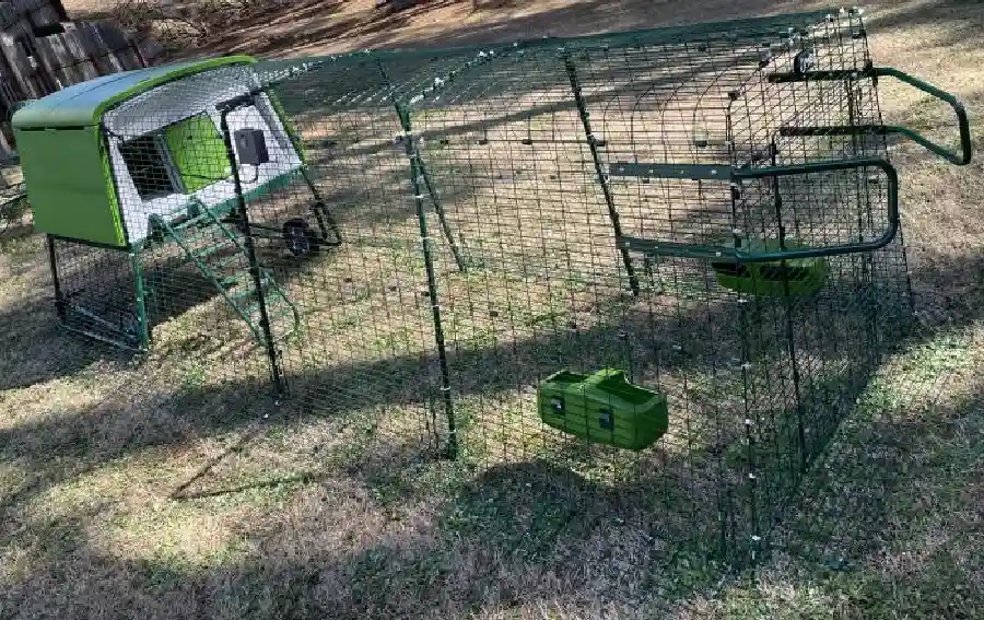 The Eglu tractor, showing the wheels on the coop and handles on the run.