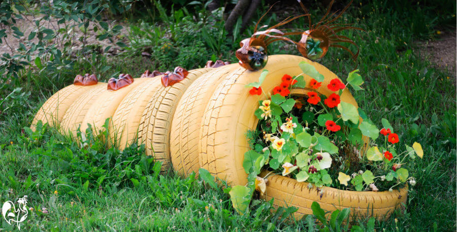 A planter made in the shape of a caterpillar containing nasturtiums.