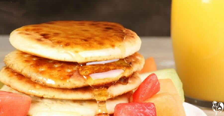 Scotch pancakes with syrup and orange juice.